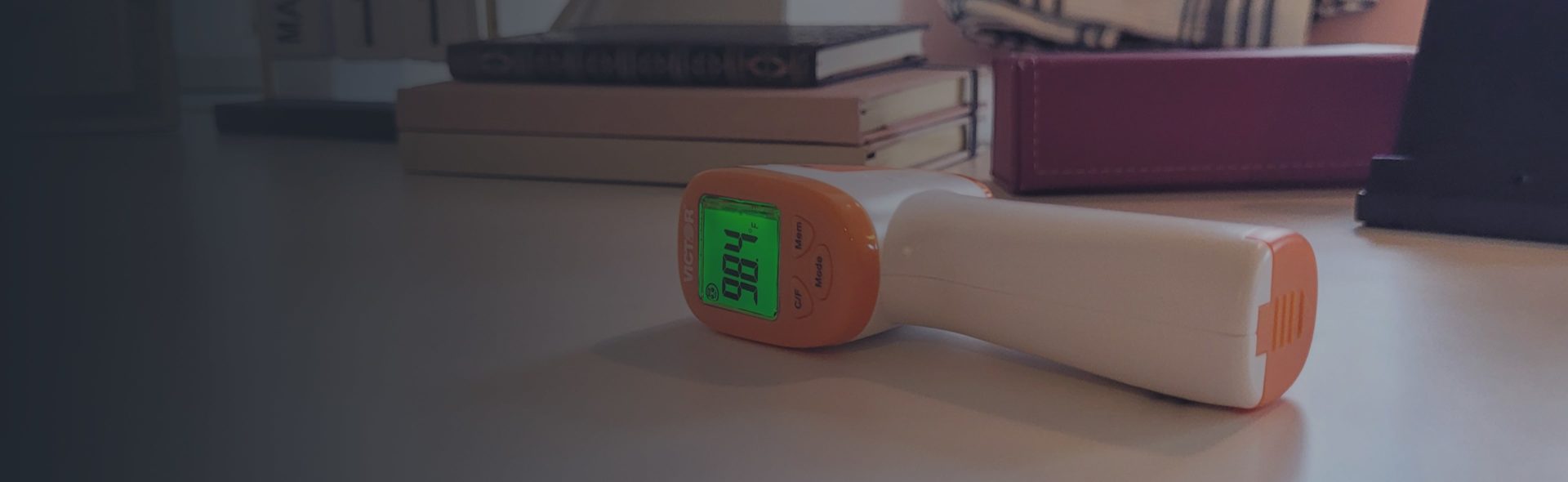 An electronic thermometer is placed on its side on a table.